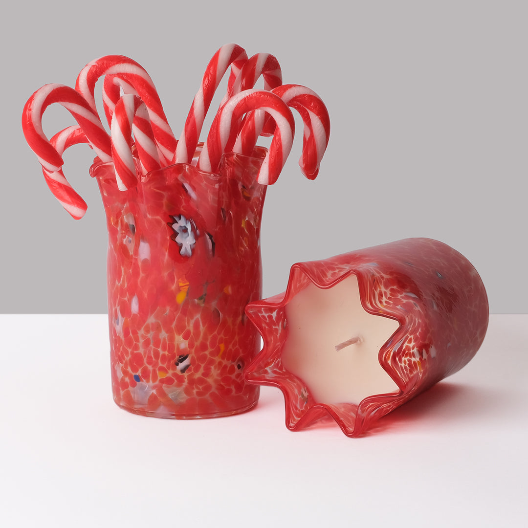 Festivum Scented Candle with one candle and one vessel holding candy canes