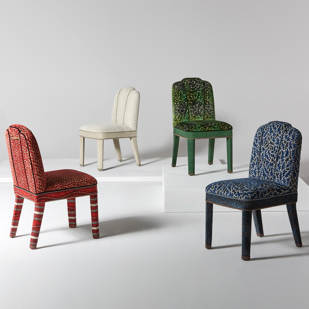 Set of four Abbas dining chairs in red, cream, green, and blue patterned upholstery